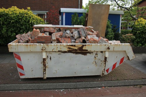 Commercial waste removal van parked in Deptford street outside a shop