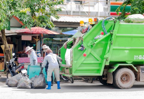 Workers loading rubbish into a van near Deptford Market Yard